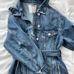 Denim jacket with a belt.